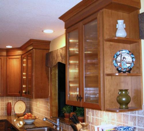 The dark cherry cabinets complement the oak trim of the house