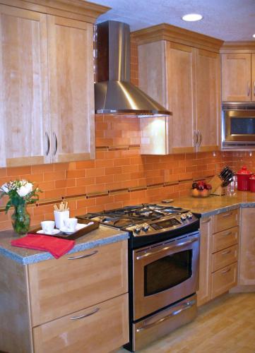 The hand-made tiles with rich spice color are this simple kitchen's focal point