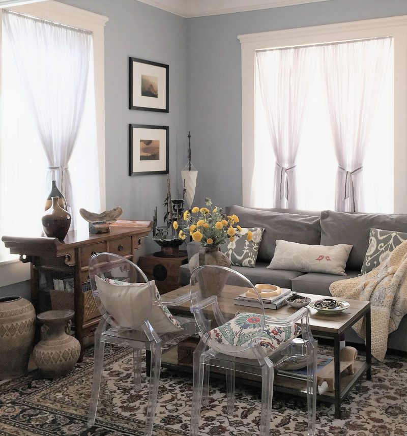 A small living room with soft color and eclectic furniture style)