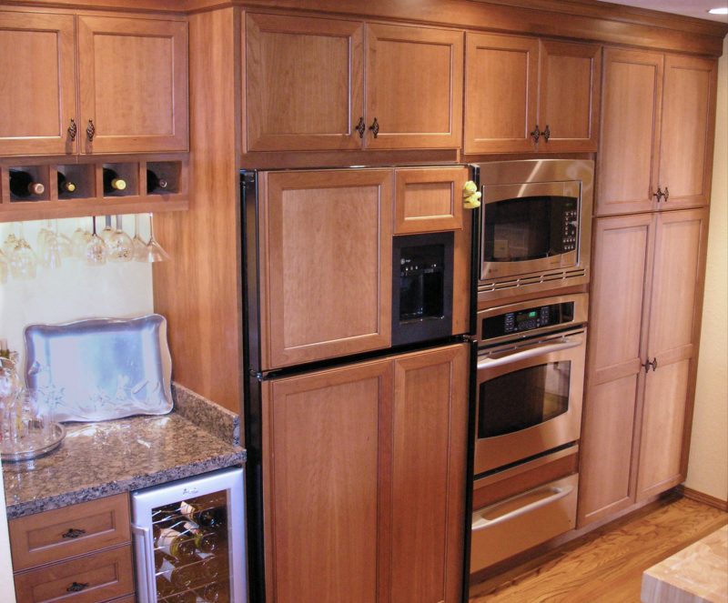 A built-in refrigerator with custom wood panels creates a clean look