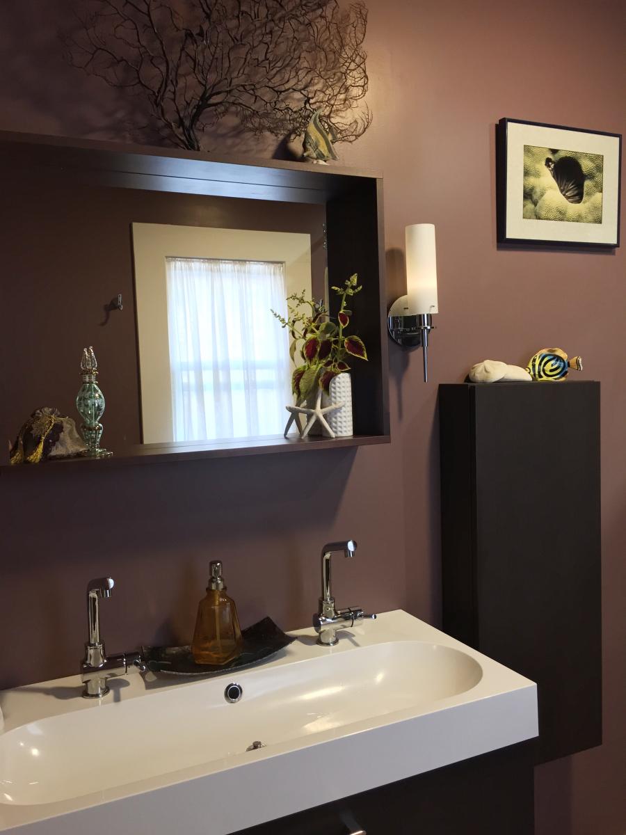 A budget friendly bathroom with Ikea hanging cabinet and double vanity providing a spacious feel