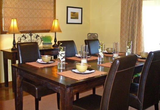 A dining room with rich color and custom window and door coverings